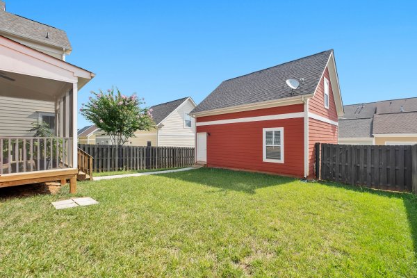 fenced in backyard with a red shed